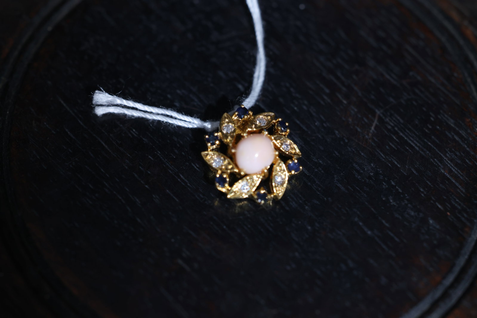 14K Gold Natural Conch Pearl Pendant with Sapphire and Diamonds: Jade is intact with no chips or cracks; setting is secure. Minor localized wear to the gold plating. Opal shows no significant abrasions. Pin mechanism is in good working order. Weight: 1.5 carats;