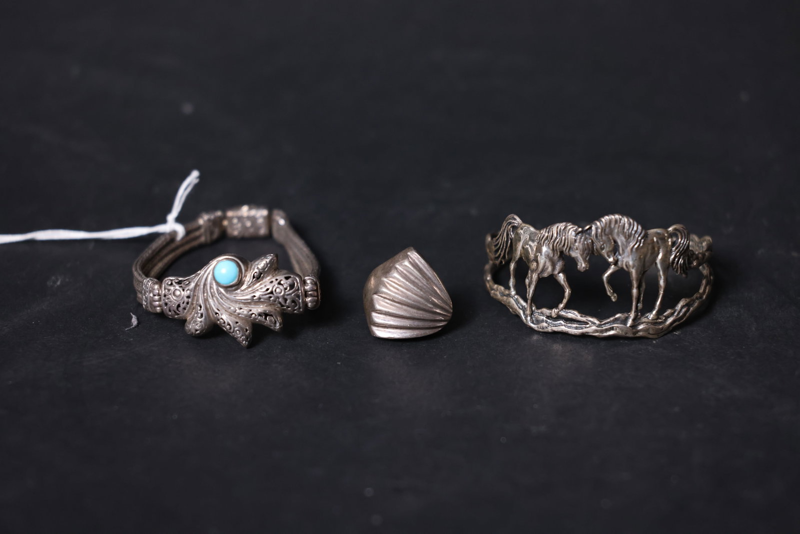 Group of Antique Western Silver Jewelry: No breaks or losses; silver shows oxidation and darkening; woven chain is intact; turquoise is well preserved; ring shank with minor wear; bracelet opens and closes smoothly; no signs of repair. 79g