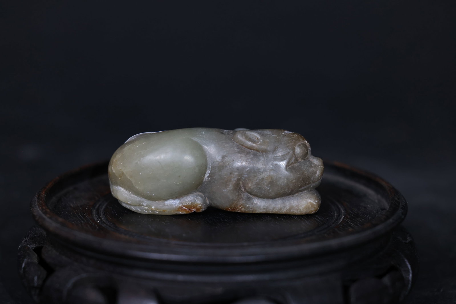 Carved Hetian Green Nephrite Reclining Beast Toggle: Overall intact with some age-related cracks and wear; rich patina; no recent chips or breaks. H 25cm W 7cm