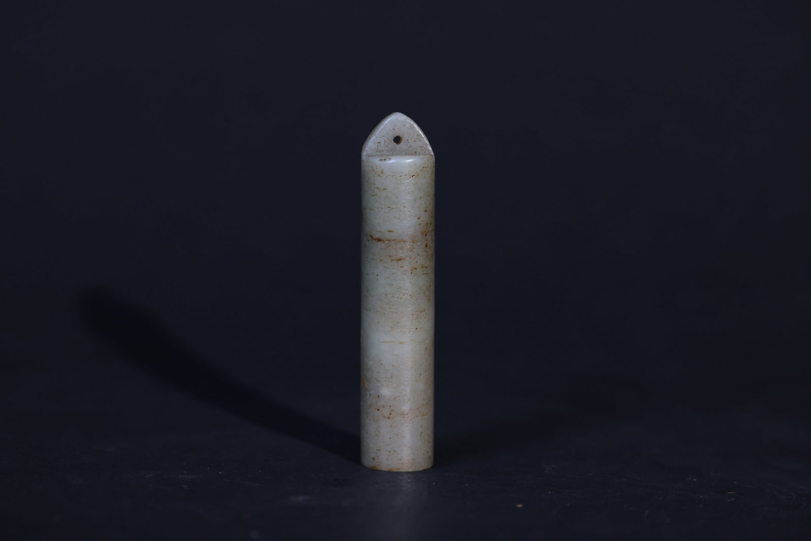 Qing Dynasty Hetian (Hotan) Jade "Lingguan" Ornament: The piece is intact with no breaks or chips. It exhibits natural age patina and fine "ox-hair" surface lines throughout, with minor soil encrustations in some areas. The interior and perforations