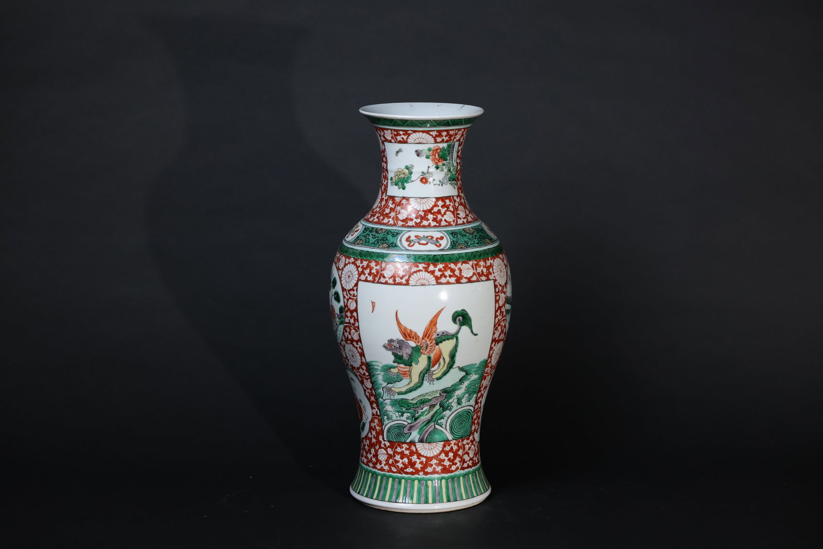 Late Qing wucai Guanyin-form vase decorated with auspicious beasts, landscapes and flowers: Minor wear to the rim, slight loss of enamel in some areas, no cracks or chips detected. The base has an artificial drill hole, and the footrim shows traces of old soil. H 46cm W 20cm