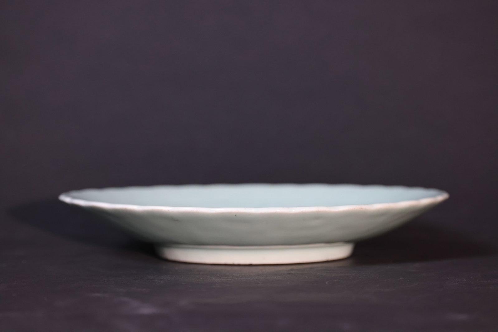 Jiaqing (Qing dynasty) douqing-glazed incised-lotus petal-rim large charger: Minor wear to the rim, one glaze contraction spot on the surface, no cracks or restorations, overall in good condition. H 4.5cm W 28.5cm