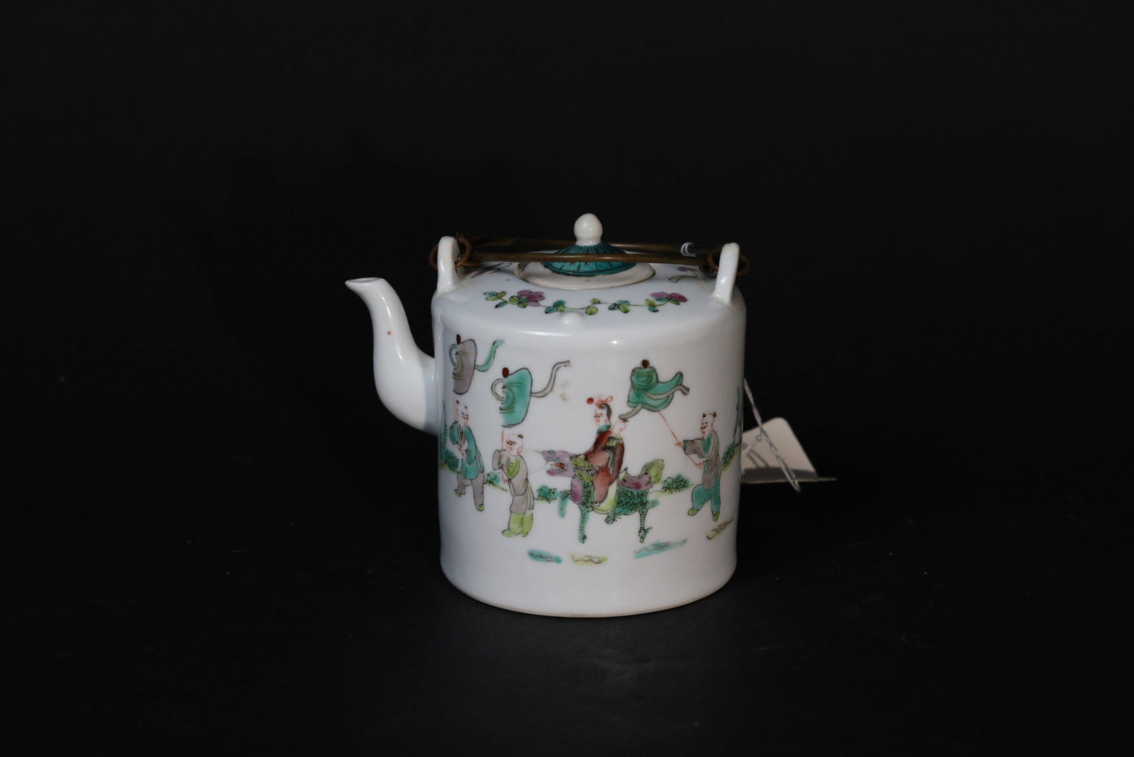Qing Tongzhi Famille Rose "Qilin Delivering a Child" Double-Faced Bridge-Handled Ewer: Overall in good condition; the teapot lid has a casting line, which is the main flaw. The body is free from chips or cracks. The bronze handle is original and shows normal wear consistent with age and