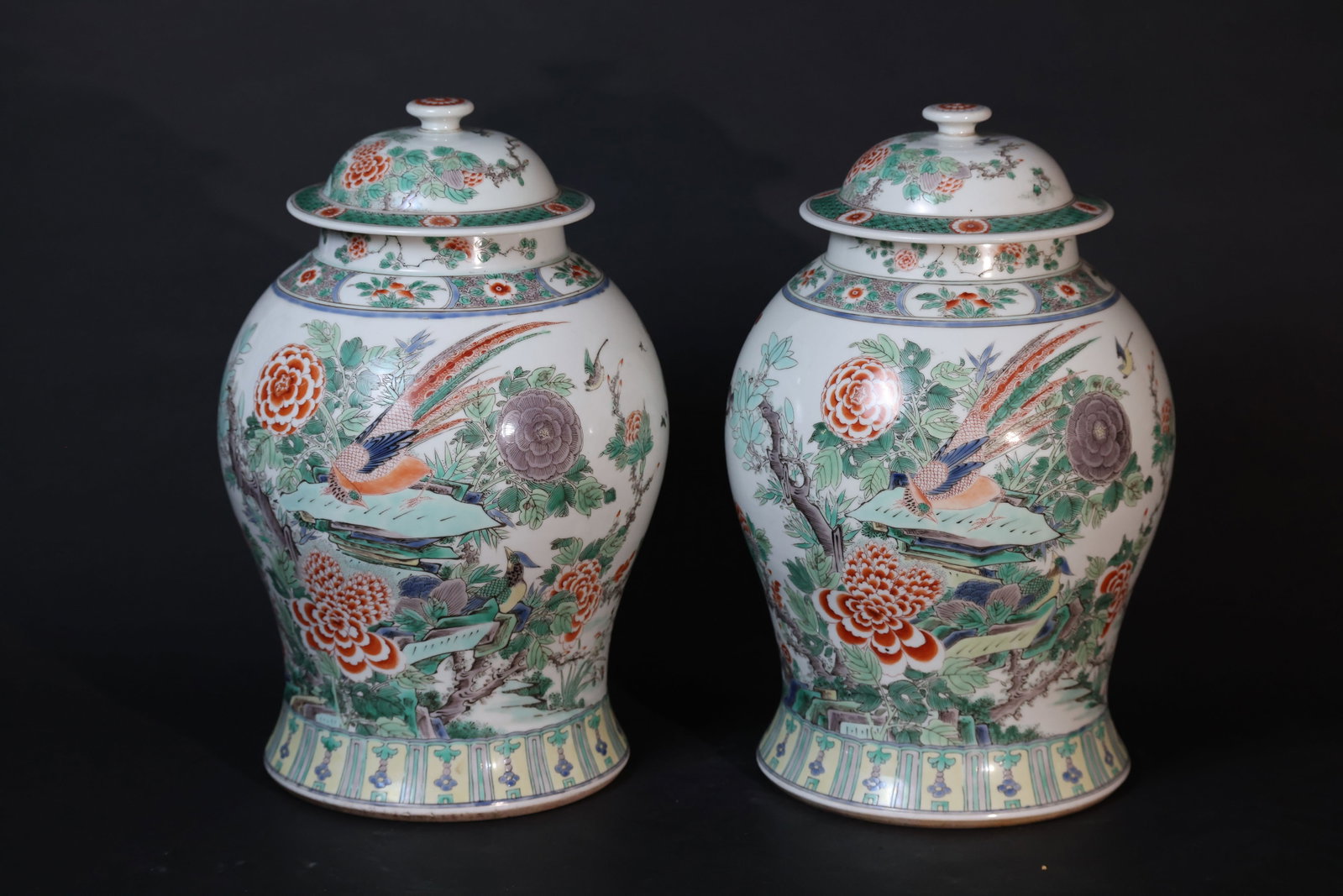 Pair of Wucai "Da Jiangjun" Jars with Golden Pheasant and Peony Decoration: One of the pair has a minor nick to the rim; the main body of the jar is intact. The enamels show slight wear consistent with age. No hairline cracks. Overall, the piece is in good condition. H 39cm W