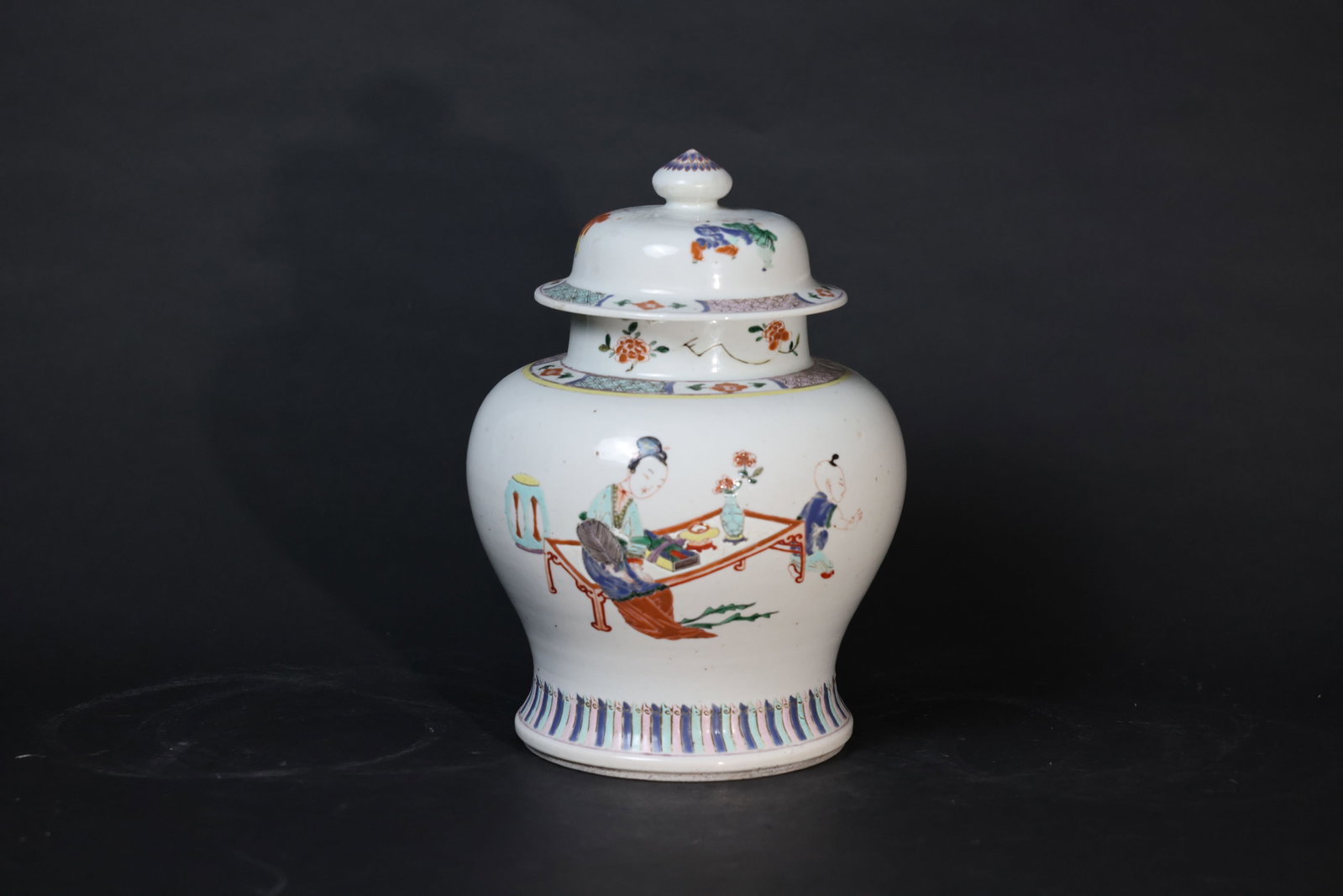 Chinese Wucai Jar Depicting Court Ladies and Children at Play: No cracks or chips to the body; minor wear and slight loss of enamel in some areas; cover intact; rim and foot with expected wear consistent with age. H 29cm W 20cm