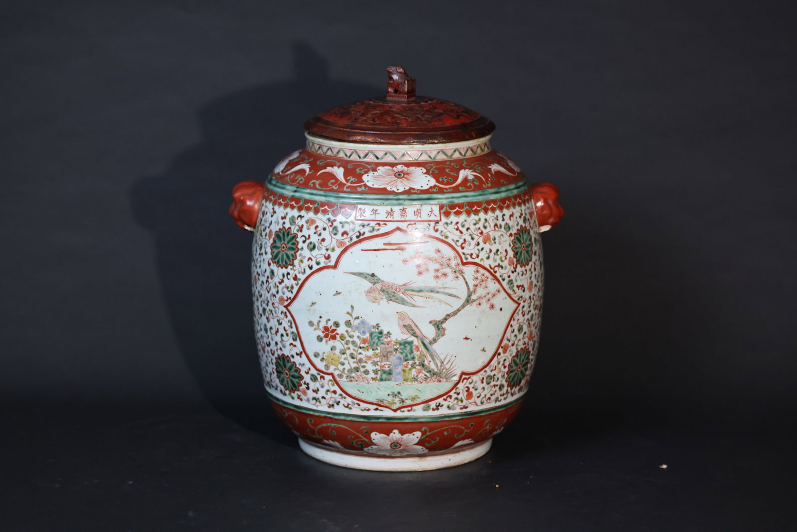 A Rare Large 'Wucai' 'Flora and Fauna' Jar with Beast-Mask Handles, Mark and Period of Jiajing: The jar appears to be in overall good condition with no apparent chips or hairline cracks to the porcelain body. Minor expected surface wear and localized tiny rubbing/flaking to the overglaze enamels