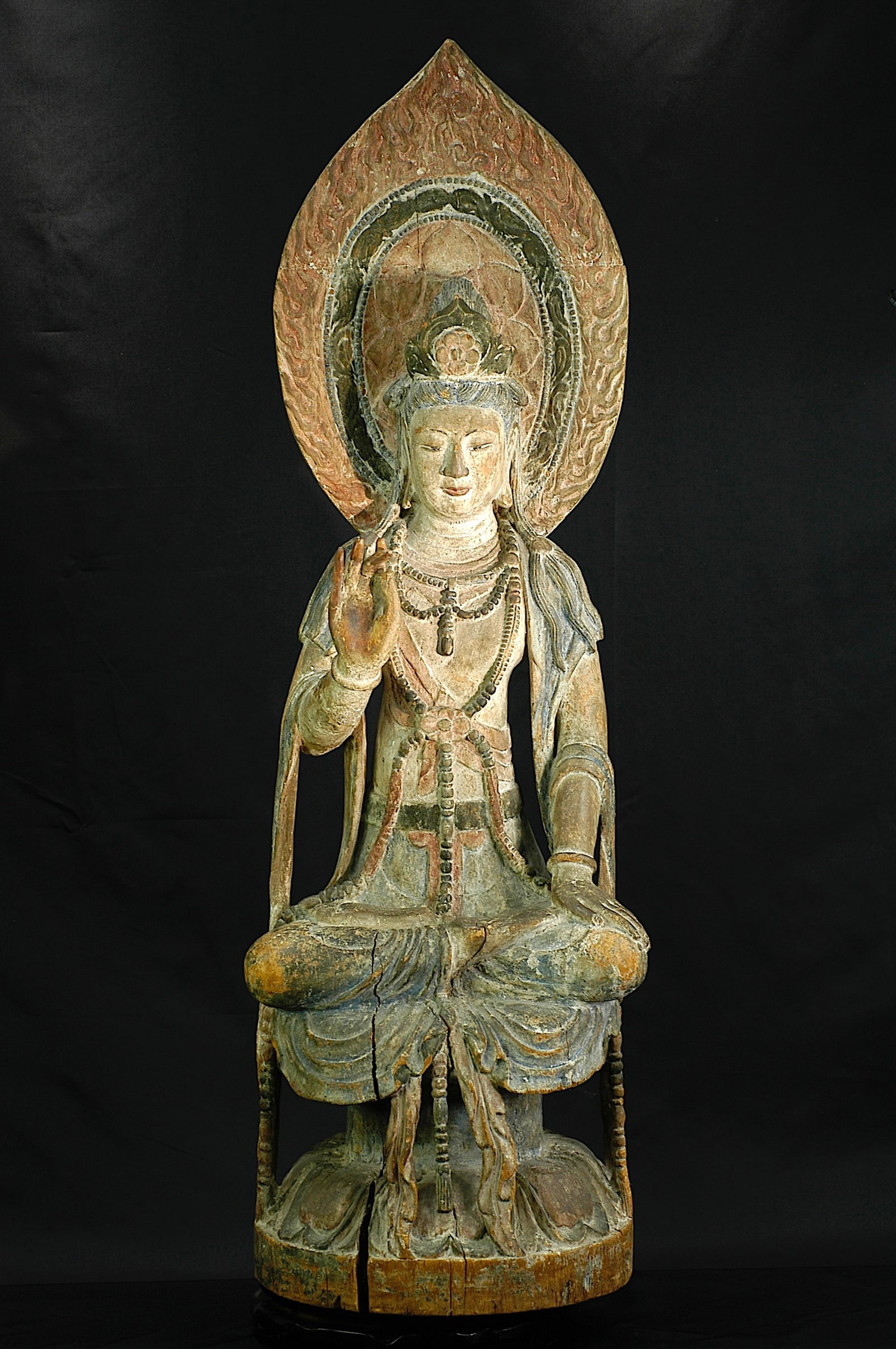 Liao Dynasty Shanxi-Style Seated Carved Wood Guanyin: Naturally aged and used, natural color immersion and color fading, naturally cracking, the body has connected restoration, right hand has restoration, and two fingers have chips, all the rest is in go