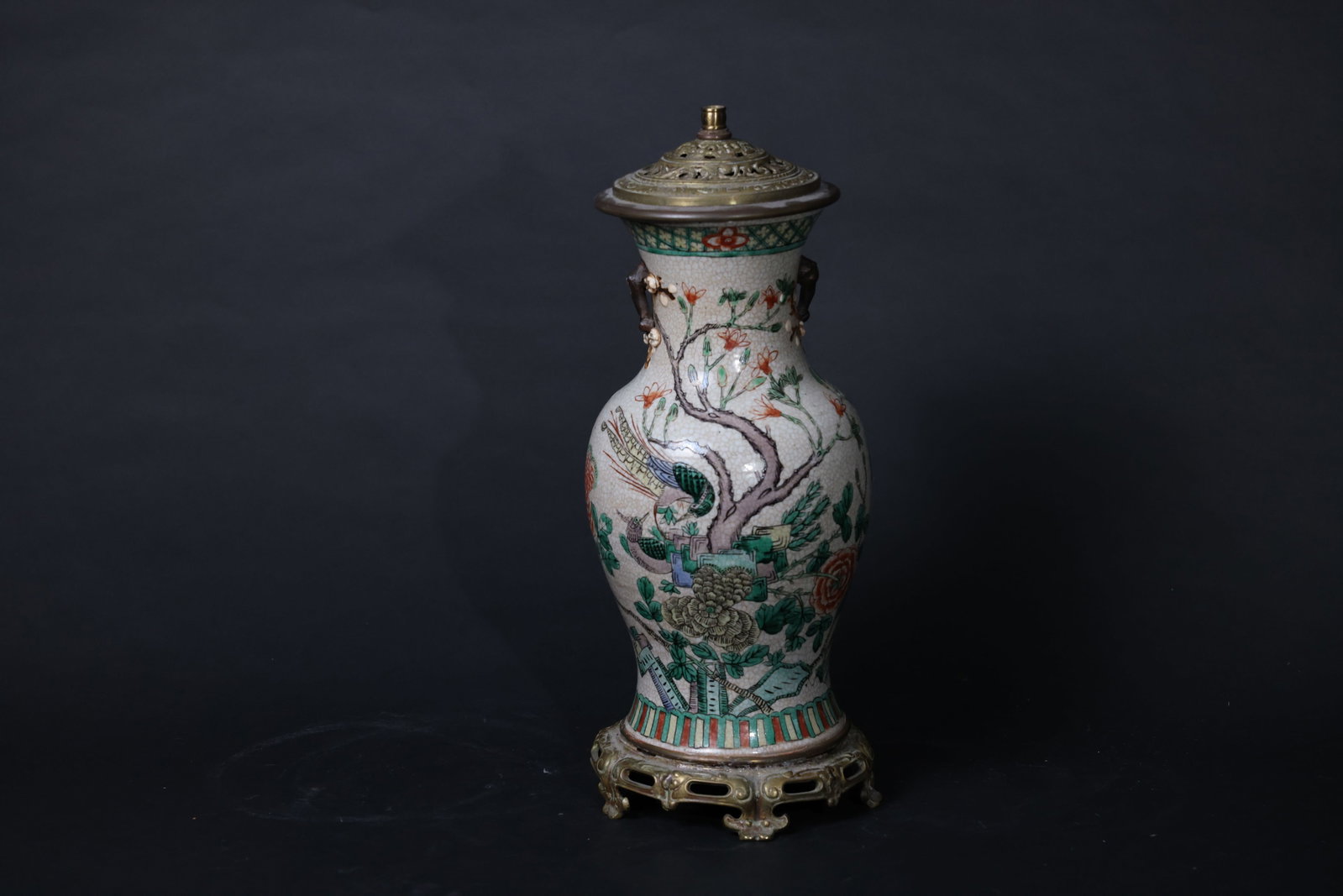 Late Qing Ge-Glazed Wucai "Phoenix and Peonies" Vase with Plum-Flower Handles: The porcelain body is free of cracks or chips, with minor wear to the enamels in some areas; the brass fittings show age-related oxidation and verdigris, and the top is fitted with an aperture for a l