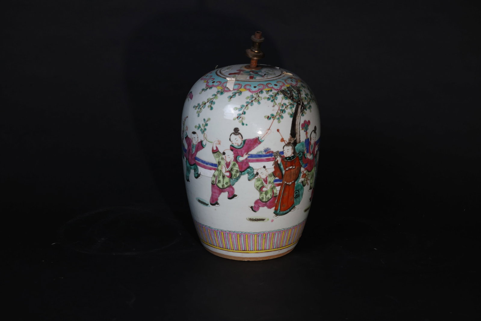 Late Qing Famille Rose Winter-Melon Jar with Children at Play: The body is intact with no firing lines; some localized enamel wear and loss. The rim has a drilled hole. The original cover is missing and later replaced with a metal lamp fitting. H 34cm W 18.5cm