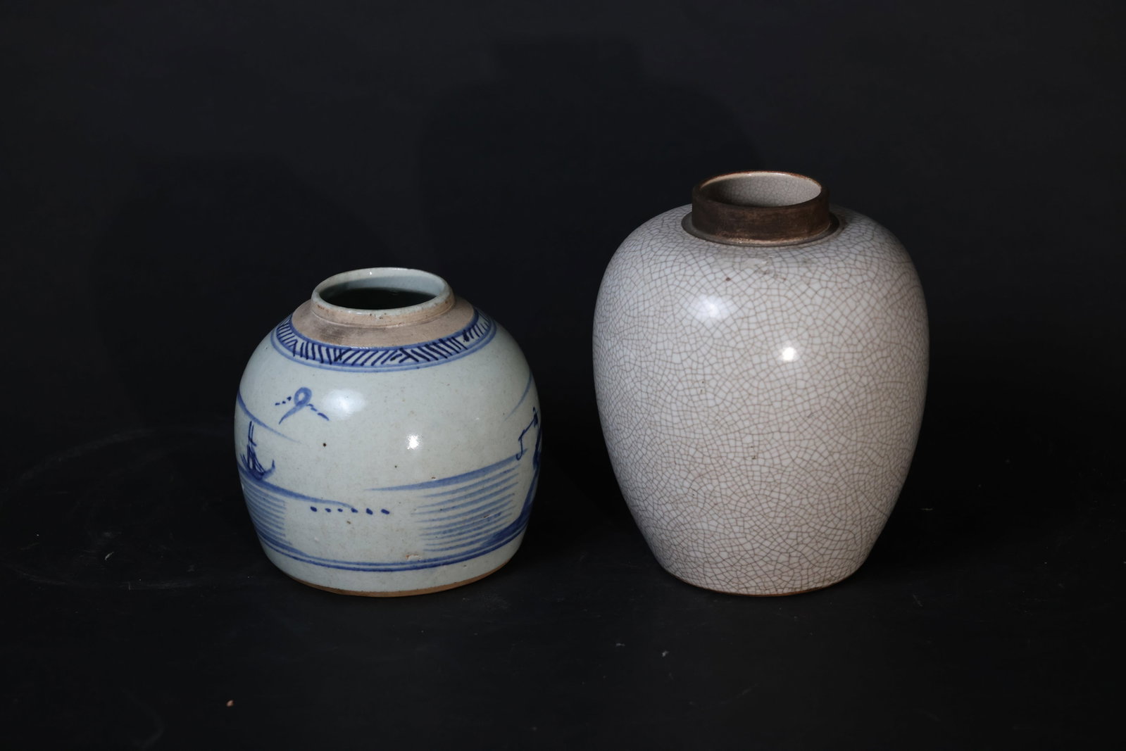 Mid-Qing Blue-and-White Landscape Tea Caddy; Late Qing Ge-Glazed Crackle Jar: Mid-Qing Dynasty blue and white landscape tea caddy: Fine hairline cracks to the base, rim intact, body without damage, lacking cover, with surface wear from use. Late Qing Ge-type crackle-glazed jar: