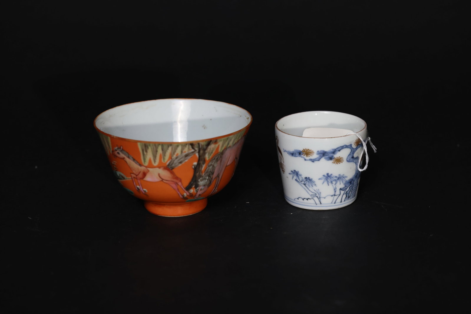 Late Qing/Republican Coral Famille-Rose Eight Steeds Bowl & Blue-and-White Pine Bamboo Plum Cup: The rim of the "Eight Horses" bowl shows minor enamel wear, with some old usage stains inside the bowl. No cracks or restorations; overall intact. The straight-sided cup with pine, bamboo, and plum mo