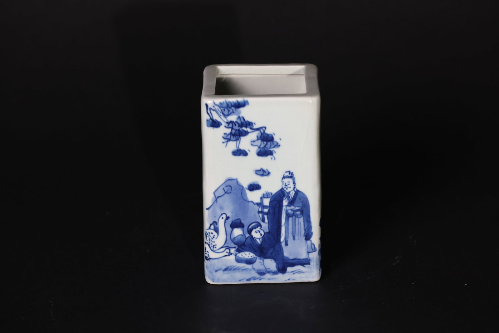 Chinese Blue-and-White Square Brush Pot Depicting Figural Story Scenes: The rim is intact. There is a prominent mold line along the side of the body. The foot shows minor wear, with no chips or losses. H 12.5cm W 24cm