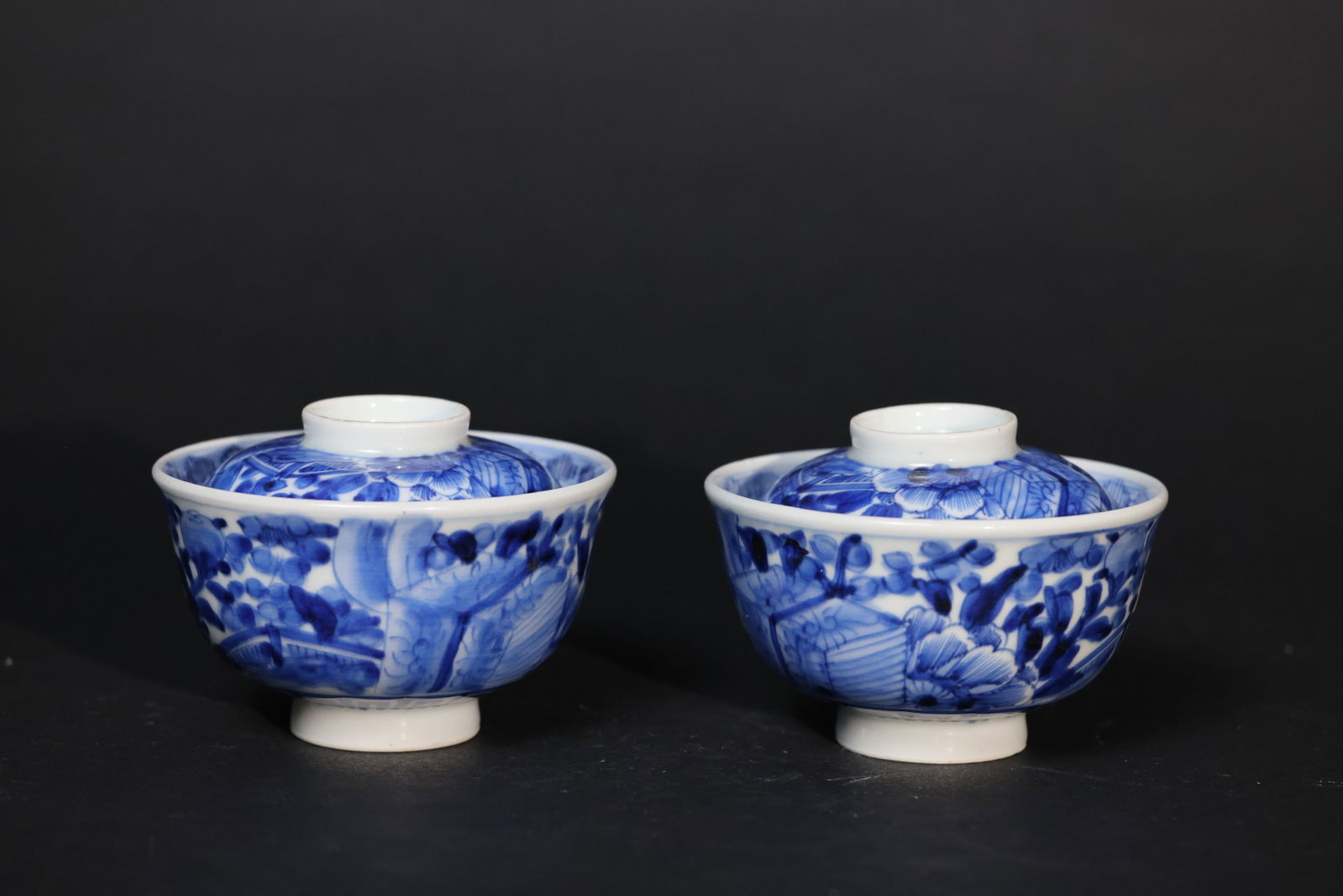 Pair of Late Qing Blue-and-White Gaiwans with All-Over Floral and Banana-Leaf Decoration: Overall intact with no cracks or breaks. The rim and foot show minor wear consistent with age and use. The lid fits the bowl well. H 7.5cm W 10.5cm