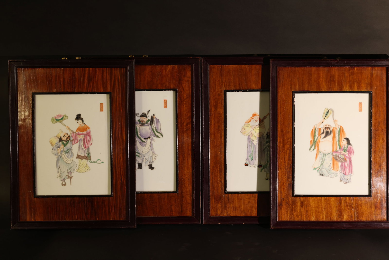Pair of Reverse-Painted Glass Hanging Panels Depicting Court Ladies: The porcelain plaque is intact with no significant cracks or chips; the wooden frame shows signs of age-related wear and minor paint loss. Overall, the set remains in good condition. H 50cm W 37cm