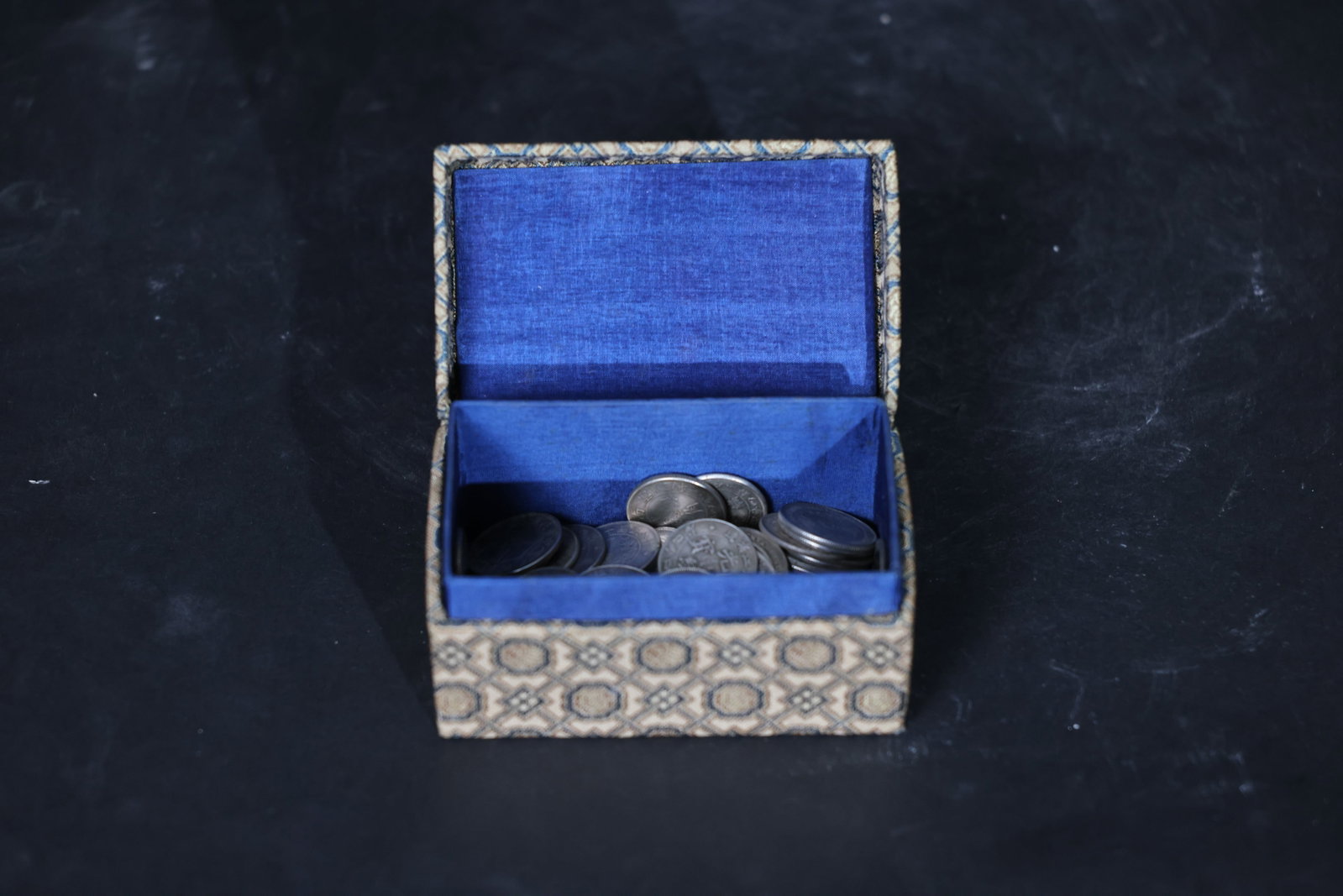 Group of Qing Dynasty and Republic of China Small Silver Coins: General wear to coin surfaces; some coins show oxidation and dark toning. Presentation box with minor edge wear, no splits. 77 coins