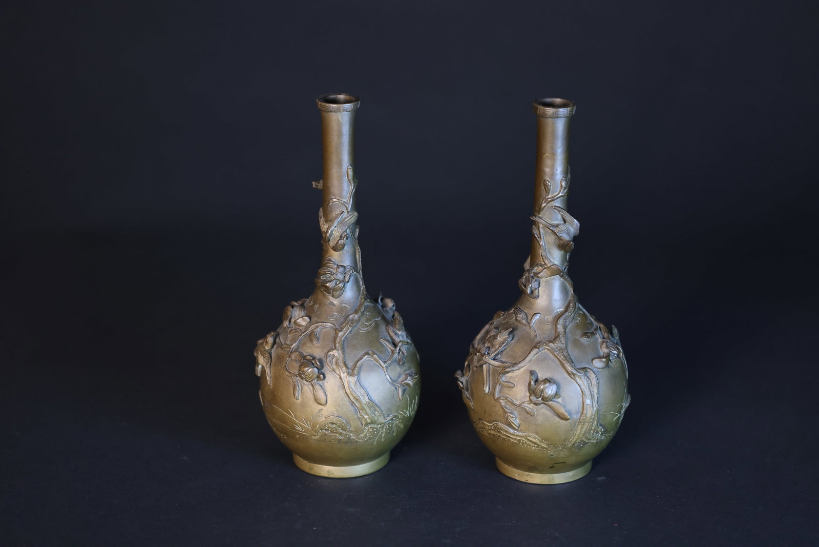 Pair of Republic of China Bronze High-Relief Flower-and-Bird Long-Neck Vases: 1. Naturally aged with patina and signs of use. 2. Naturally aged with patina and signs of use; two areas with minor chips, otherwise in excellent condition. H 24.5cm W 10.5cm