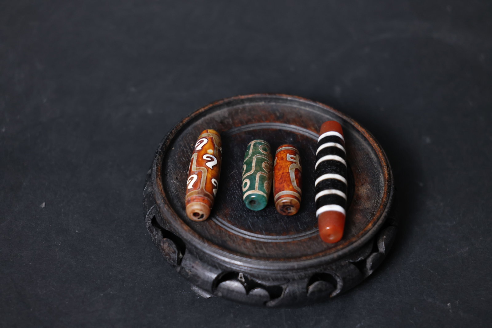 Contemporary Dzi Bead Set: All four beads are intact with well-preserved perforations; surfaces exhibit intentional aging and weathering patterns, with no chips or fractures. H 7cm W 1.5cm