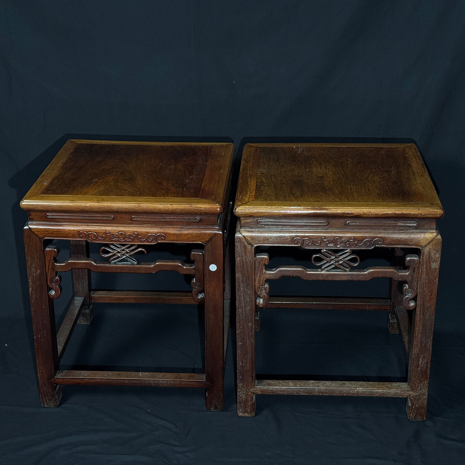 Pair of Late Qing carved hongmu square stools with chilong and Chinese?knot motifs: A well-matched and complete pair with sturdy mortise-and-tenon construction. The original patina is naturally developed, with age-related wear and scratches to the seat surface, and minor old knocks