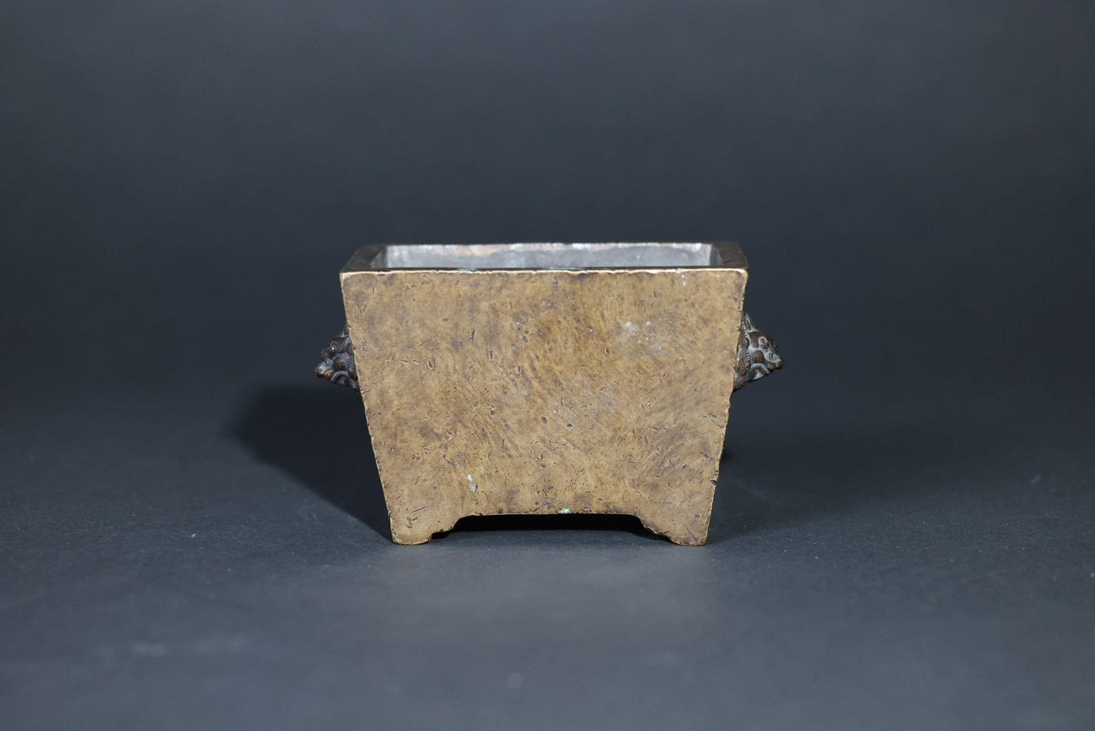 Qing Dynasty Bronze Square Censer with Beast-Head Handles: The body is intact with well-cast beast ears. The surface shows an attractive, mature patina with minor wear in places. The base mark is indistinct. No major cracks or perforations; normal signs of