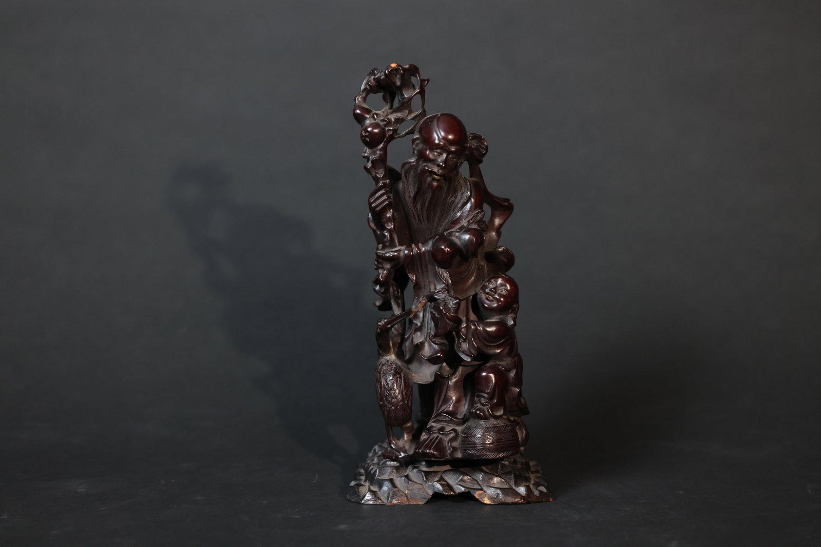 Chinese carved wood Shou Xing (God of Longevity) with boy attendant and crane: Rich, well-developed patina. Minor old nicks to the tip of the cane and slight age-related wear to the delicate openwork. The main figure and crane are intact, with no major cracks or repairs. H