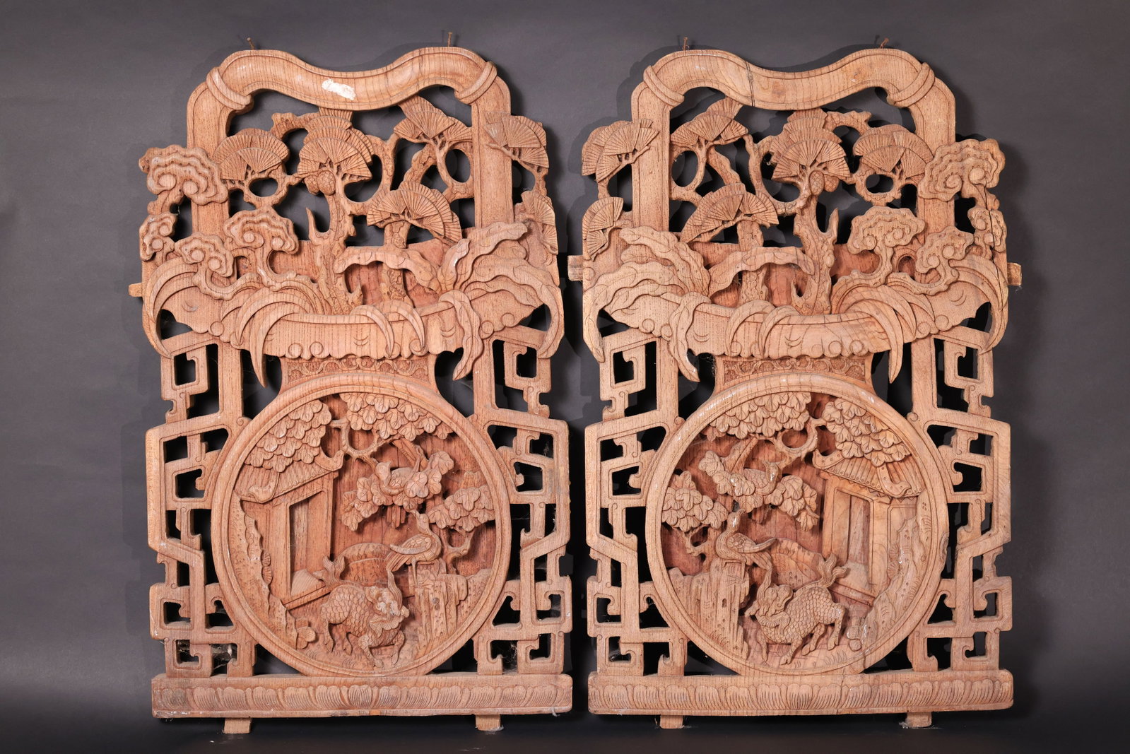 A Pair of Pierced-Carved Pine, Crane and Qilin Panels with Auspicious Scroll Motifs: A complete pair with minor chips and losses; surface with natural age-related weathering and some old cracks; no significant damage. H 75cm W 46cm