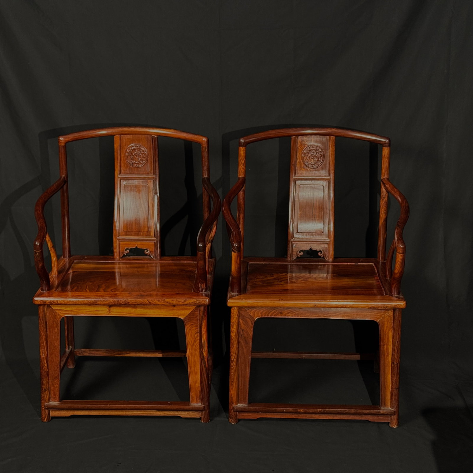 Pair of Huanghuali Nanguan "Official's Hat" Armchairs with Kui-Dragon Carvings: A matched pair, structurally sound with tight mortise-and-tenon joints; minor surface wear and small nicks consistent with age, no major cracks or losses, minimal signs of use, overall in excellent