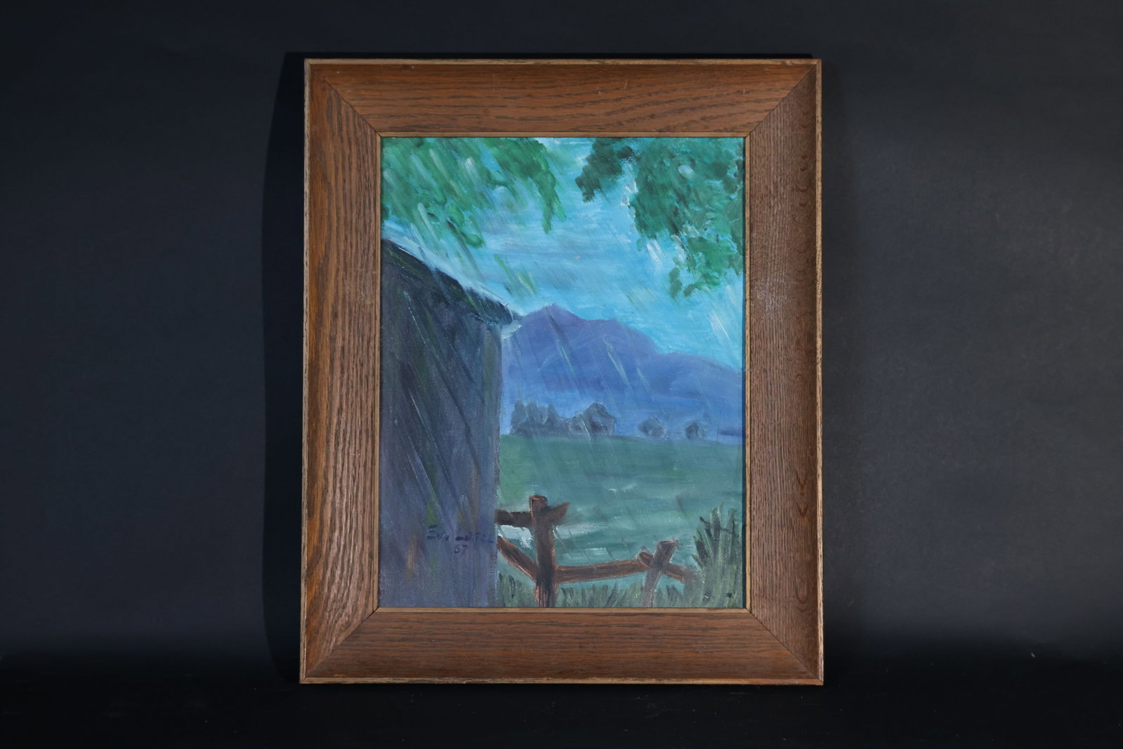 Ev. Lopez, 1967 — Rural Landscape, oil on canvas: The canvas is intact with no tears, and the paint layer is stable with only minor age-related specks. The oak frame displays a clear grain with slight wear to the corners, but no cracks. H 45.5cm W 37