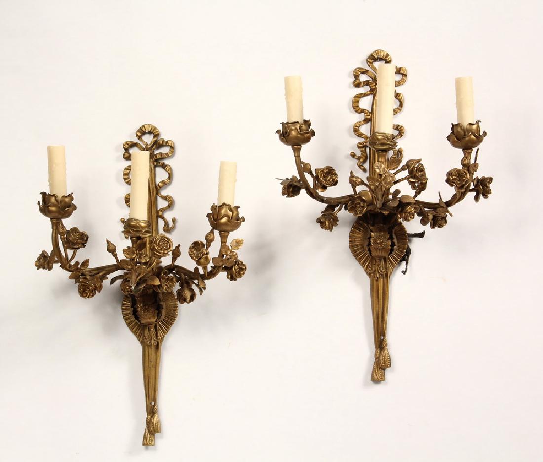 PAIR OF SCONCES: Early 20th c. French Style Three-Arm Sconces, in gold painted metal, electric, having arms and bobeches in the form of rose branches, backplate in the form of a ribbon tied bow, 21 1/2" x 13" x 9 1/4"