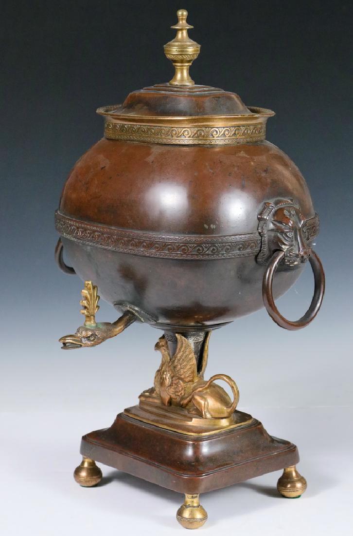 SAMOVAR: 19th c. Charles X Bronze Serving Urn, with turned top finial, lion mask and loop handles, bird head spout, griffin support, and rectangular base with round feet, 14" high, 9" wide x 8". Good condition