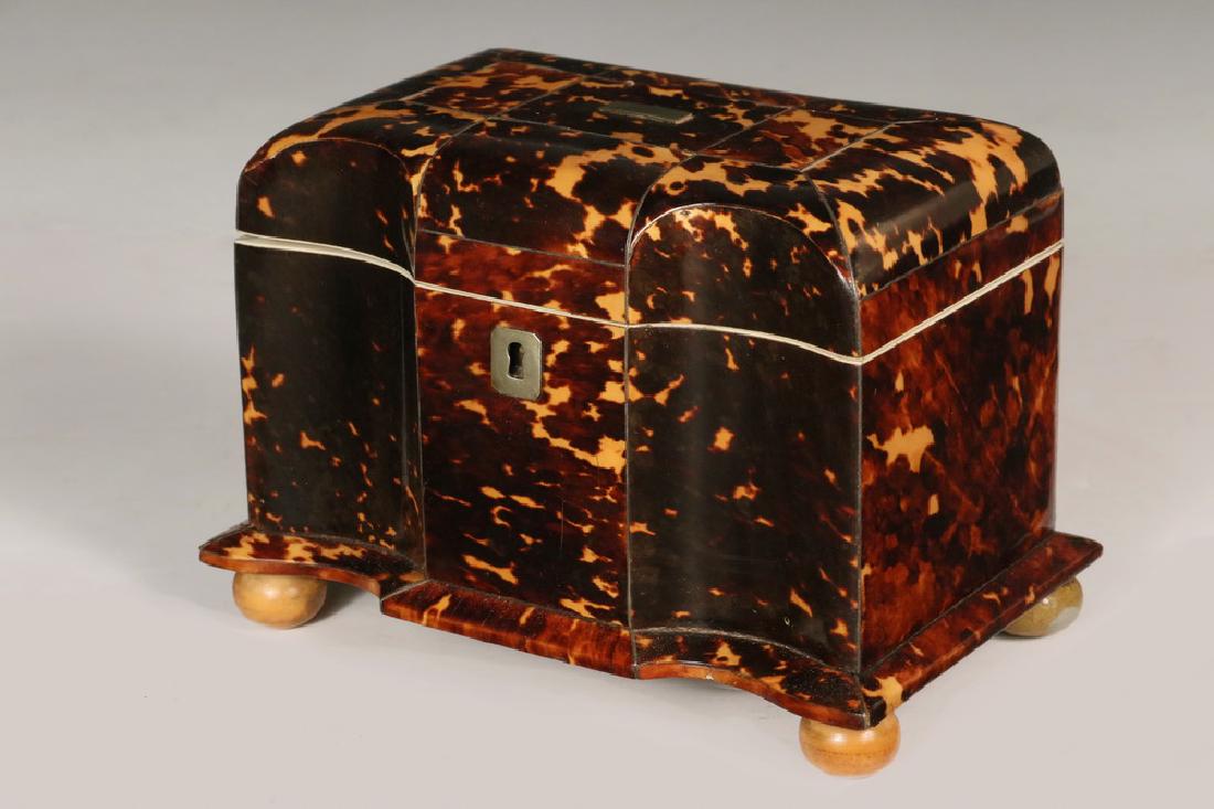 SERPENTINE FRONT TORTOISESHELL TEA CADDY: 19th c. Double Serpentine Front Tortoiseshell Tea Caddy, on wooden bun feet, with silver escutcheon (no key) and lid cartouche, velvet lined lid, two inner compartments with tortoiseshell veneered lid