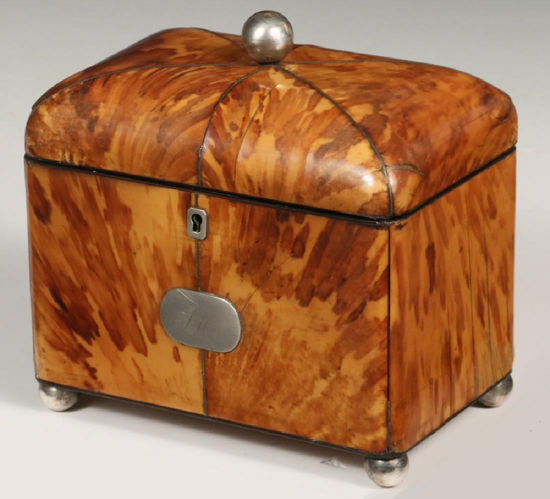 BLONDE TORTOISESHELL TEA CADDY: 19th c. Blonde Cushion Top Tortoiseshell Tea Caddy, with silver escutcheon (no key) and cartouche (monogrammed 'JH'), silver plated ball top and ball feet, velvet lined lid, metal stringing between to