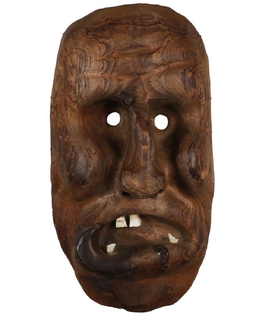 RARE INUIT MASK: Spirit Dance Mask, Ammassalik, East Greenland, carved and scorched softwood and fossilized ivory, circa 1930. Used in drum dances for religious ceremonies held during the winter. Often buried with the