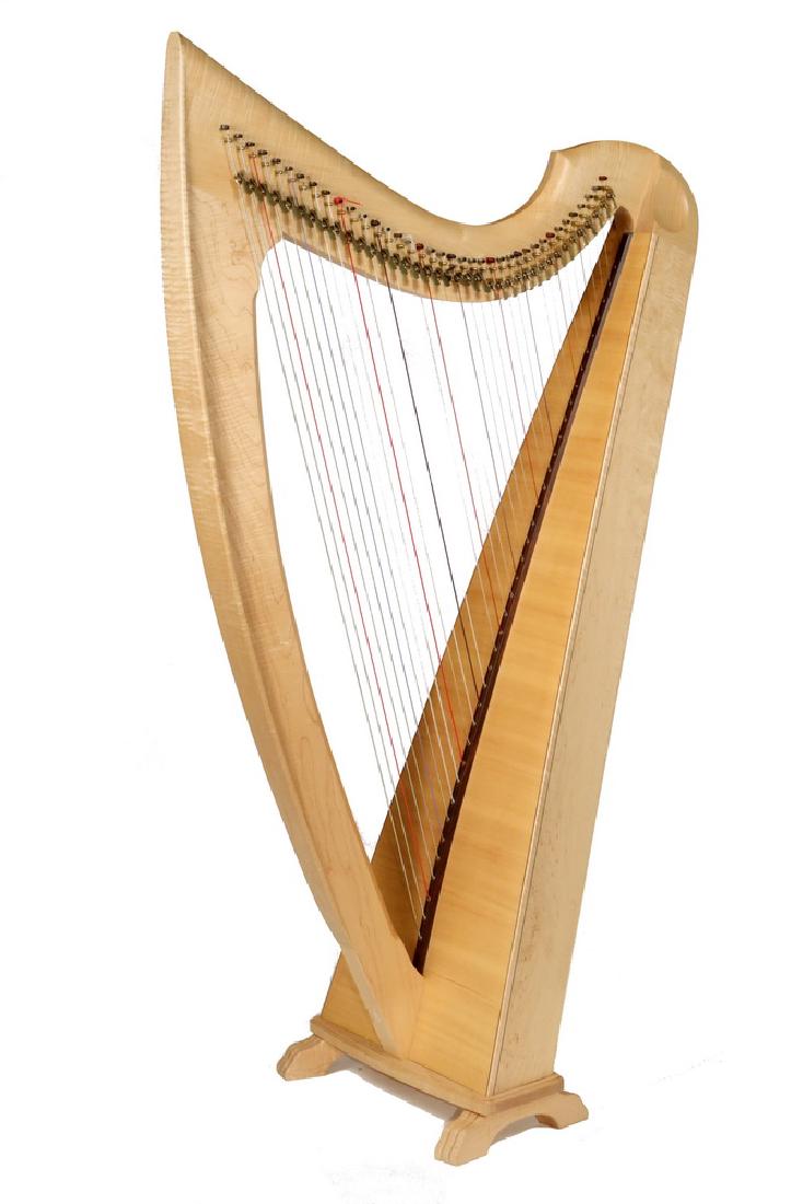 MUSICIAN'S HARP WITH SOFT CASE: Contemporary Celtic Design All Wood Harp by Triplett Harps of San Luis Obispo, CA., Premiere model, 1993, in maple. Roughly 59" x 37" x 17". Fine condition.