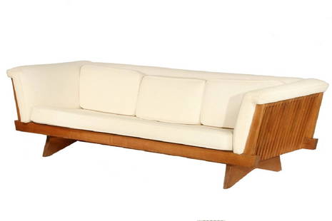 NAKASHIMA WIDDICOMB SOFA: Modernist Design Long Sofa by George Nakashima (WA/PA, 1905-1999), from the Widdicomb series, ca. 1965, having the signature slat ends, raised on shaped slab feet, in American black walnut, retaining