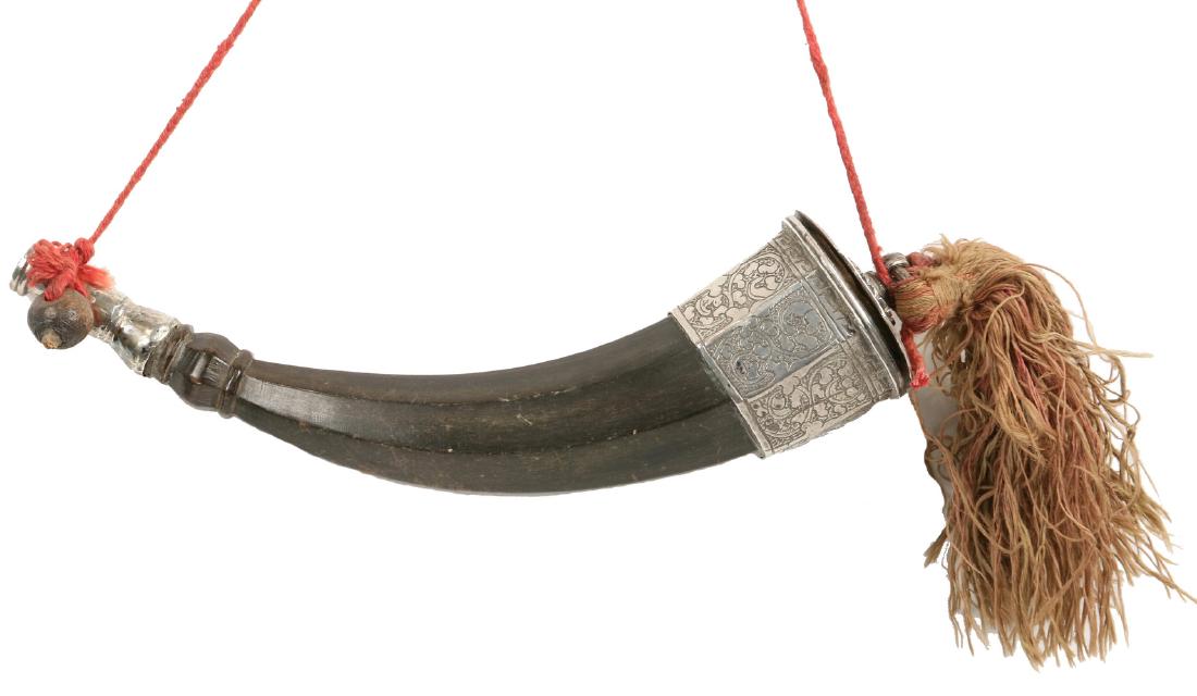 DECORATIVE POWDERHORN: 19th c. Continental Silver and Faceted Horn, having engraved decoration to the silver, silk and wool cord and tassels, probably German, unmarked, not practical. 8" long. Good condition.