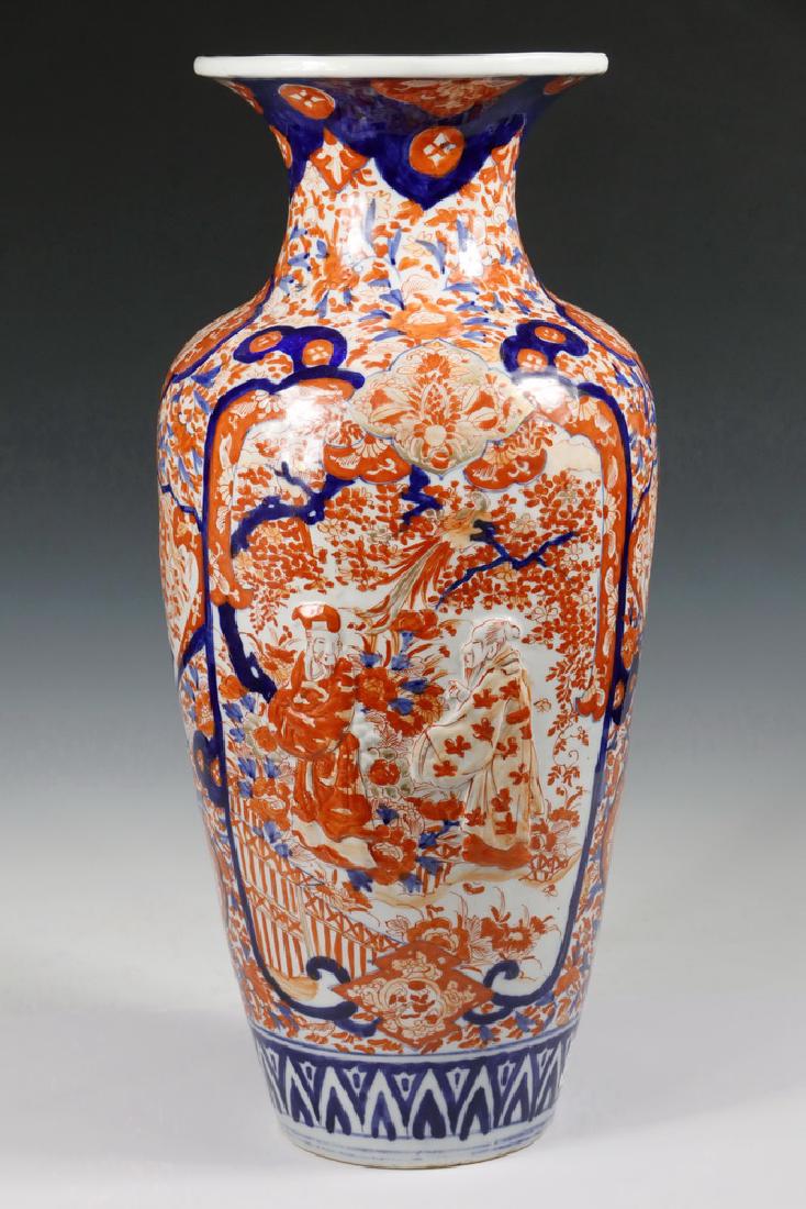 JAPANESE IMARI VASE: Japanese Meiji Period Imari Porcelain Baluster Vase, floor standing, with raised figural panels and polychrome decoration of phoenixes in prunus trees and mons, 23" high, 10" diam. Good condition, no 