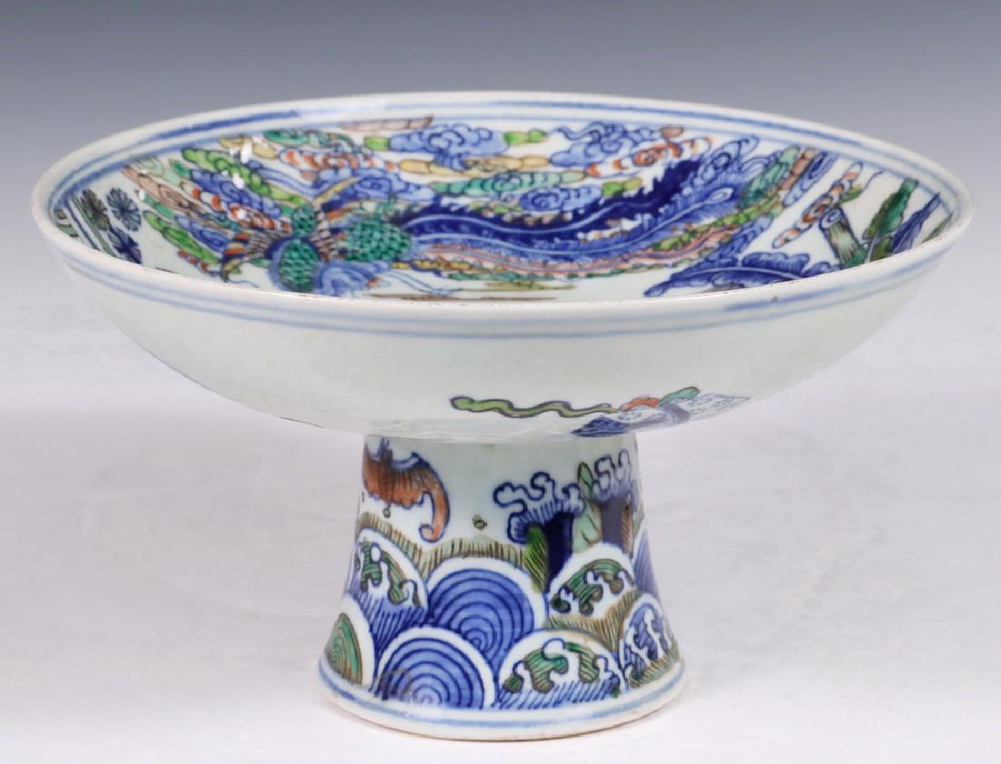 CHINESE PORCELAIN CUP: Qing Doucai Stem Cup, Guangxu mark, featuring a Kilin seated in a garden, scholar's tools on the underside, the mark inside the hollow stem, 5" x 9" diam. Good condition.