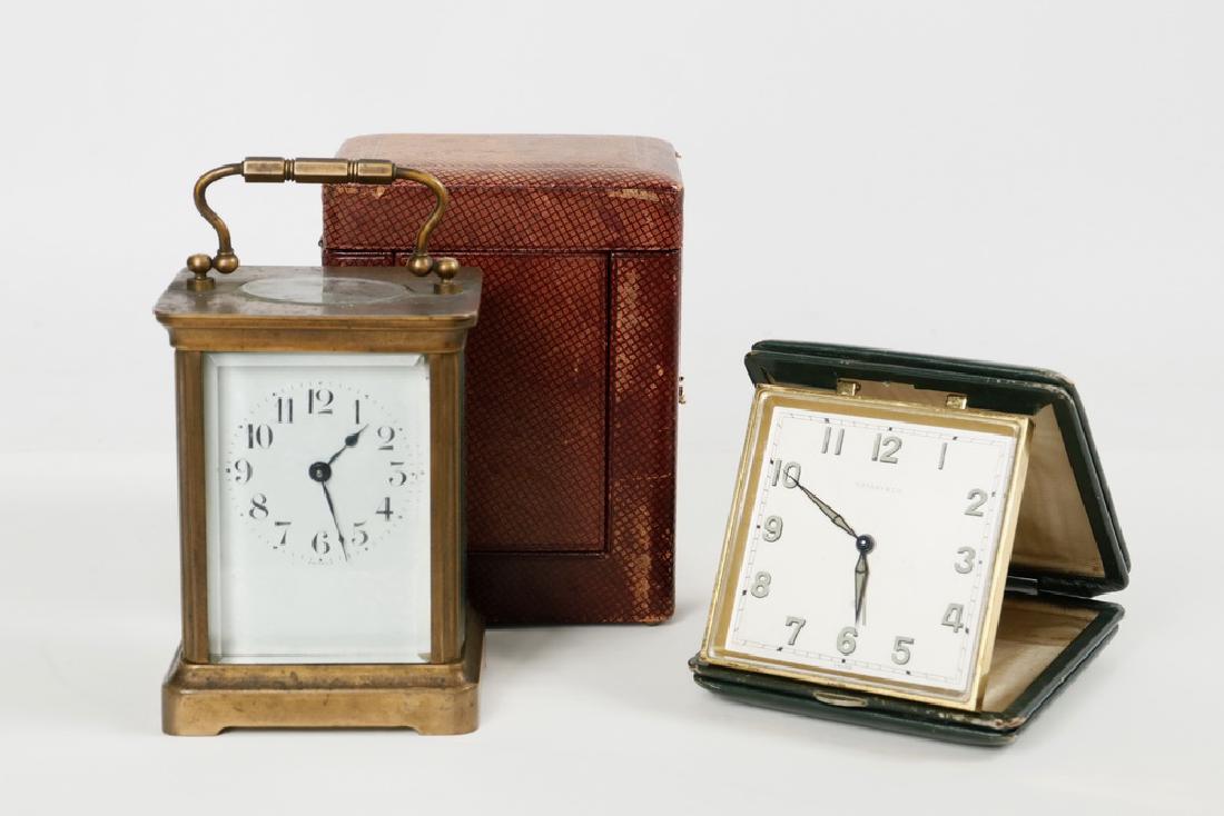 (2) CLOCKS: (2) Clocks, including: Early 20th c. French gilt bronze carriage clock with brown leather case, beveled glass sides and top, key wind time only movement (no key), with the walking lion mark of Duverdr