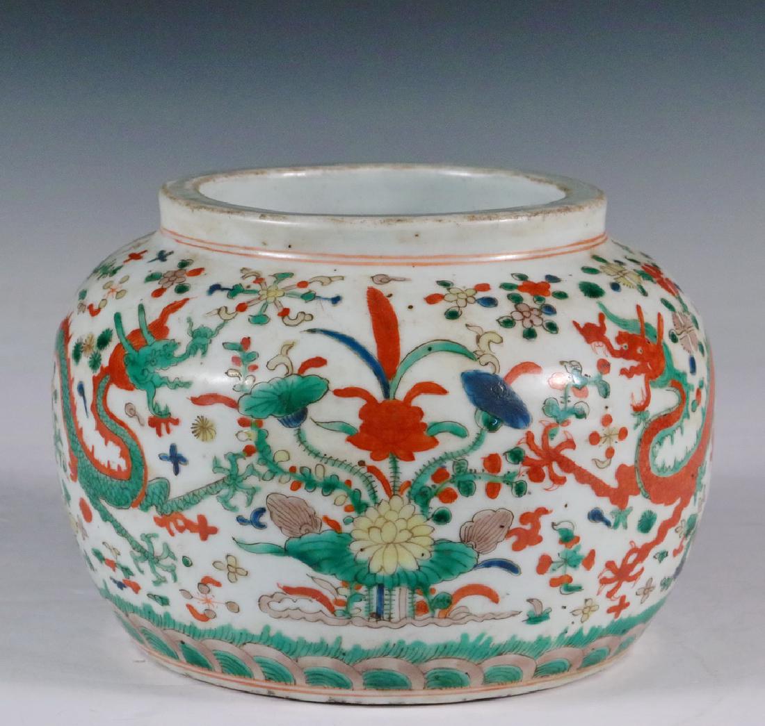 CHINESE PORCELAIN JAR: Unmarked Dao Guang Ginger Jar with Wucai decoration of two writhing dragons in a field of blossoms, a low bulbous form with heavy standing rim and recessed foot, 4 3/4" x 6 1/4" diam. Edge wear.