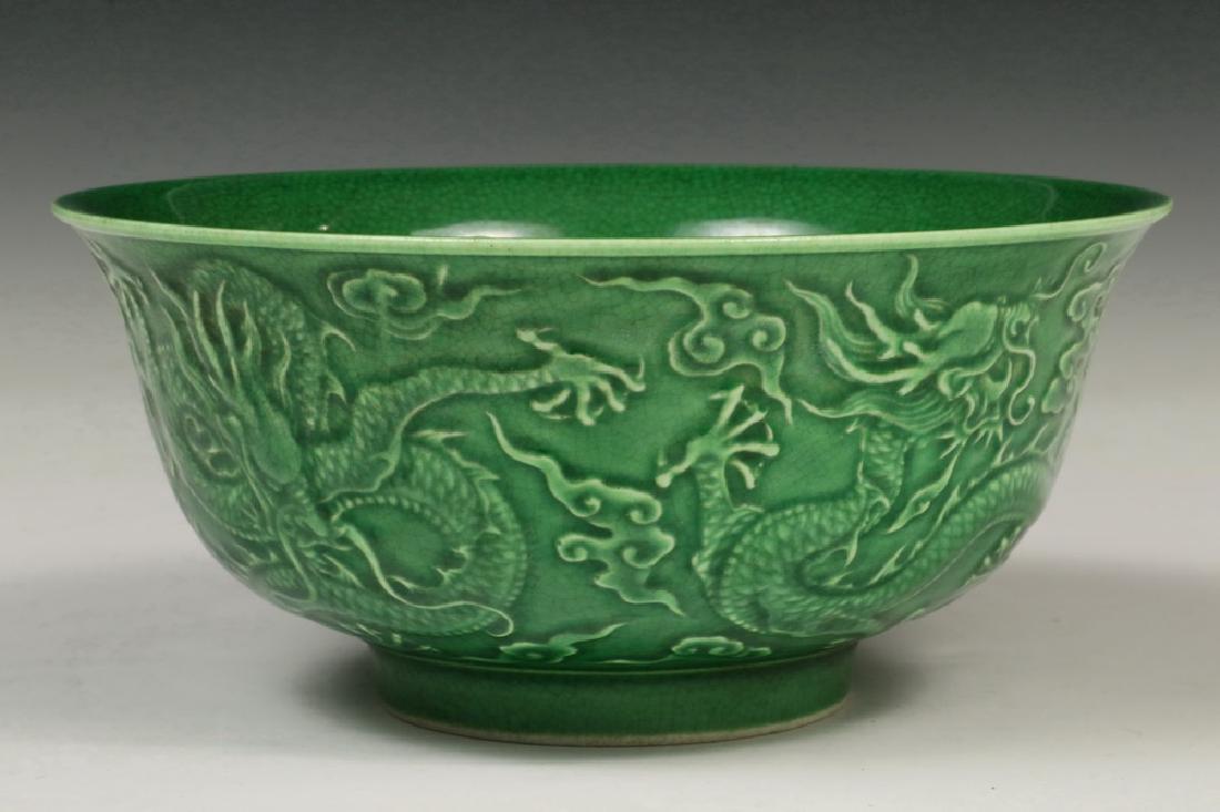 CHINESE EMBOSSED BOWL: Chinese Porcelain Footed Bowl, green crackle glaze with embossed dragon decoration, with Qianlong seal mark on base, 2 3/4" high, 6 1/8" diam. Good condition.
