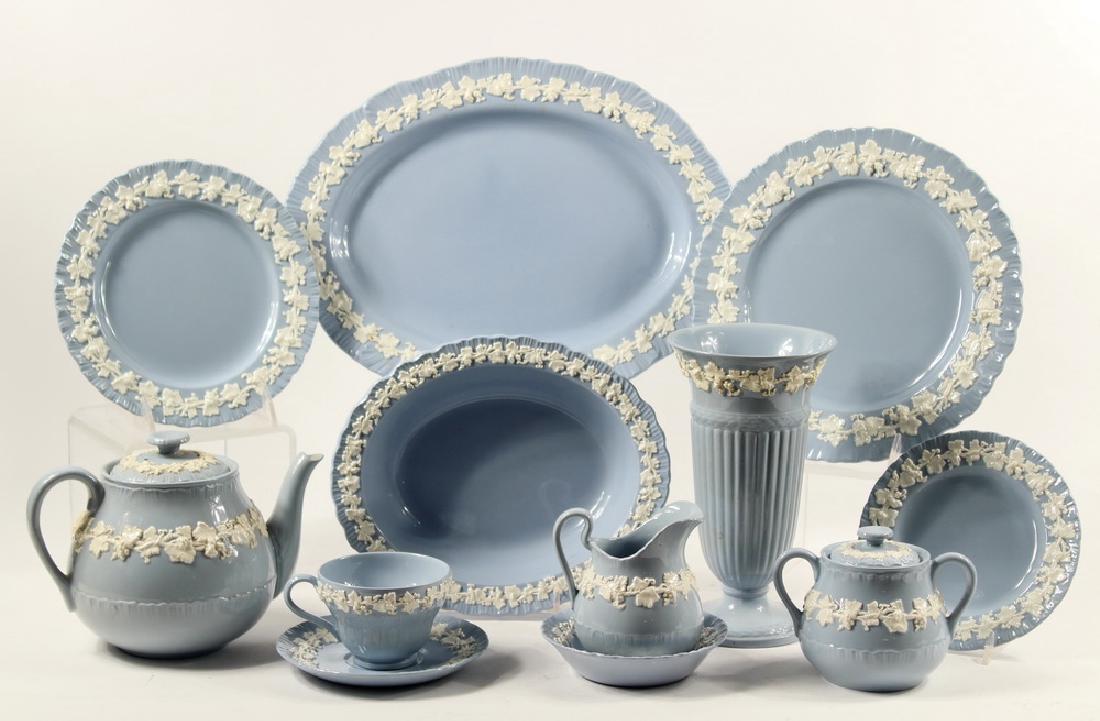 (60 PCS) WEDGWOOD EMBOSSED QUEEN'S WARE CHINA: (60) Piece Set of Wedgwood Queen's Ware White Vine on Blue Shell Edge China, including: Oval Platter, 14 1/2" x 11"; (2) Oval Serving Bowls, 2 1/4" high, 10" x 8 1/4"; Teapot, 6 1/2" high, 8 1/2" wide