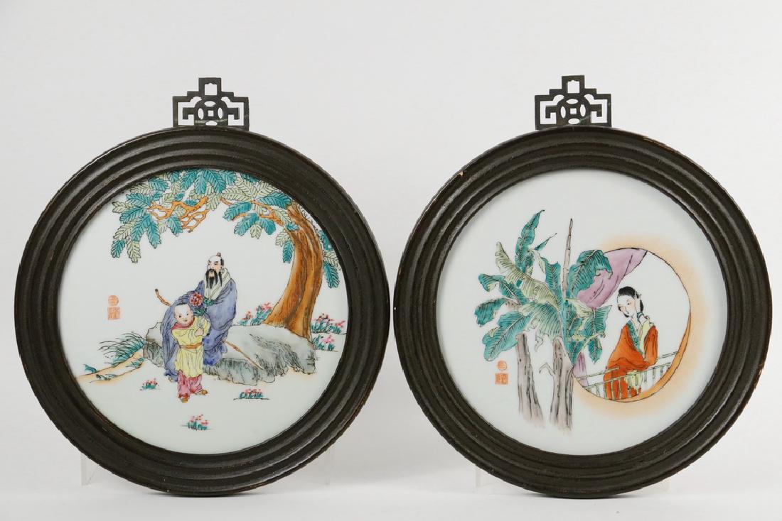 PAIR OF FRAMED ROUND CHINESE TILES: 20th c. Round Decorative Tiles in ribbed wooden frames, with polychrome depicition of a woman viewing palms from a moon window, and an elderly man seated under a tree attended by a young boy, 12' diam