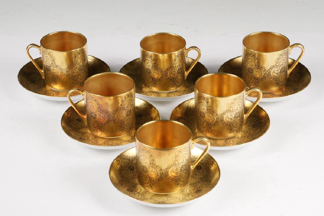 (6) ARABIA 'GILDA' DEMITASSE CUPS & SAUCER SETS: (6) Arabia Gilda Pattern Demitasse Cup & Saucer Sets, Midcentury design made in Finland, with black decoration on a gold ground, with white base and saucer wells, cup: 2 1/4" high; 4 1/4" diam. Good c