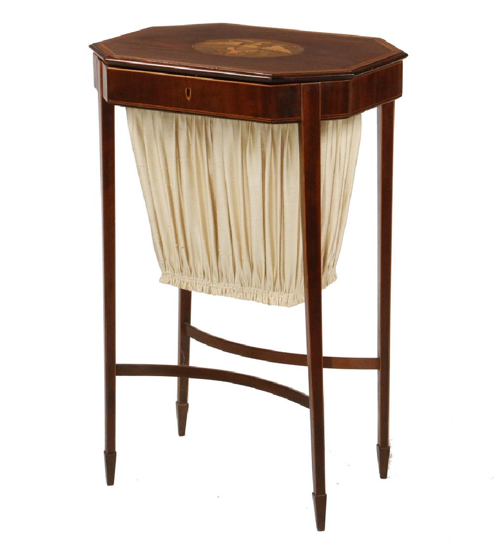 FEDERAL PERIOD SEWING STAND: Elongated Octagonal Stand, probably Boston, in mahogany with an inlaid American eagle and shield cartouche in the center of the banded edge hinged lid, the shallow case with lock and key has no drawer