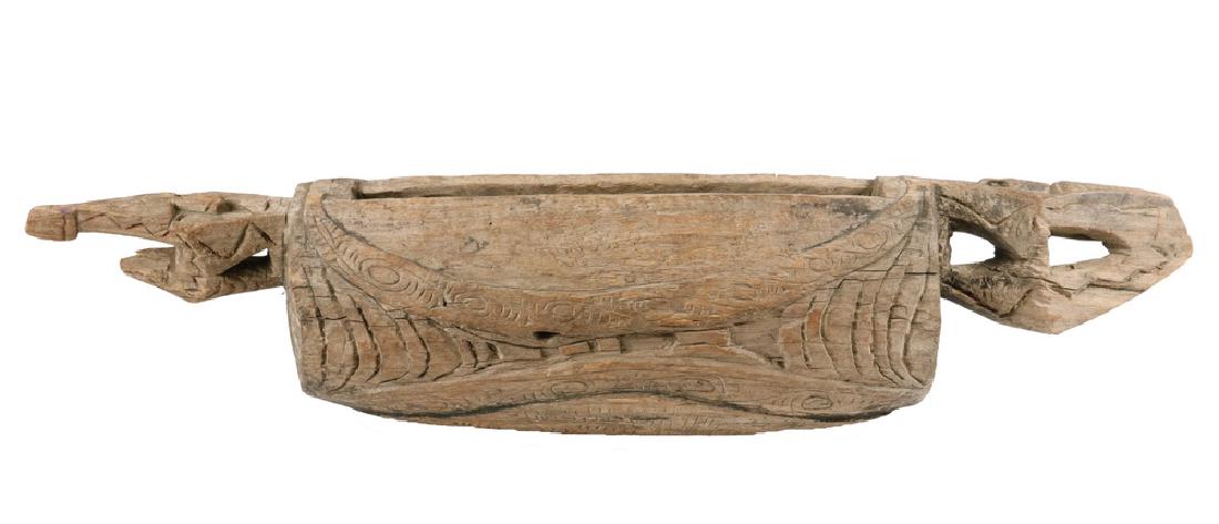 WOODEN NEW GUINEA DANCE DRUM: Hollow Wood Gong Drum in the form of a Turtle, with human faces on the underside, the pierced double turtle head ends serving as handles or used with a sling. Blackwater or Ramu River areas. Early 20t