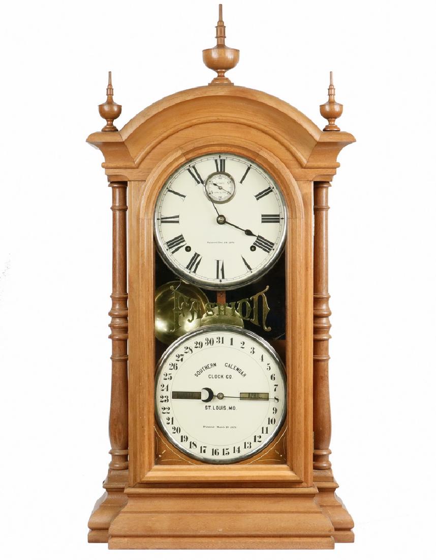 19TH C. CALENDAR CLOCK: Southern Calendar Clock Co. of St. Louis, MO. "Fashion" #4 walnut double dial having calendar at bottom with three urn finials and side columns, 8-day time and strike brass movement, latest patent is 