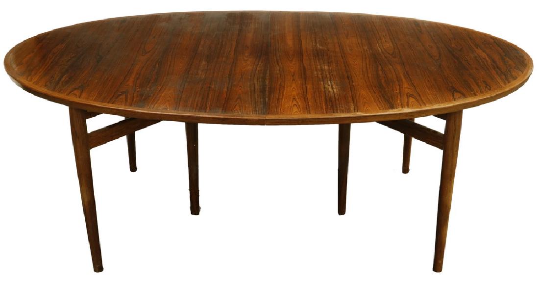 DANISH MODERN DINING TABLE WITH LEAF: Danish Rosewood Oval Dining Table by Arne Vodder for Sibast, 1960s, with label on underside, having cross banded edging, resting on a pair of three leg bases with round tapered members, 28 1/2" x 49"