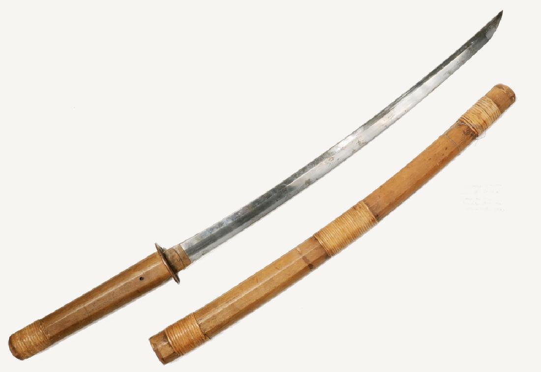 JAPANESE WAKIZASHI SHORT SWORD IN SAYA: Unsigned blade, ca 1850, with simple rattan wrapped handle and scabbard, the copper tsuba having three chrysanthemums, 21 1/2" blade, 31" long overall, good condition. Old tag reads "Japanese Samurai 