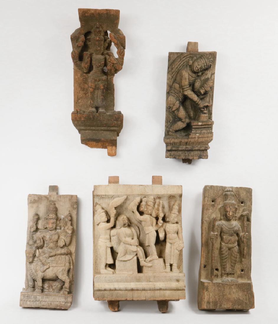 (5) EARLY HINDU TEMPLE CARVINGS IN WOOD: All 19th c. Mughal India, in hardwood, figural, narrative, the largest with a multi-headed deity crowning a prince, 13" x 10 1/2" x 3", excluding the mounting keys; PLUS Standing multi-armed deity hol