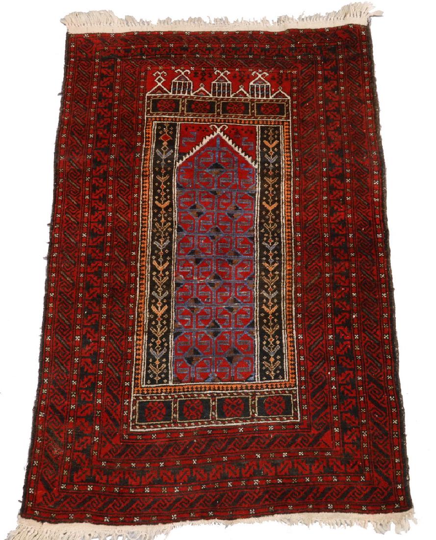 BALUCH PRAYER RUG - 3' x 4'-8": Northeast Persia, mid-20th c., compartmented octagons in sky blue, midnight blue, aubergine and ivory, set inside the red mihrab, red meander border. Good condition.
